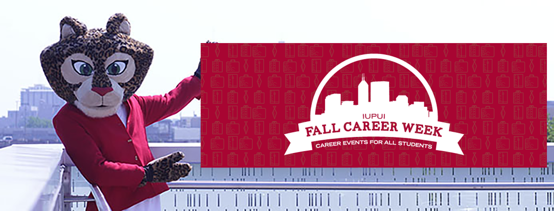 Jazzy the Jaguar mascot pointing to fall career week banner